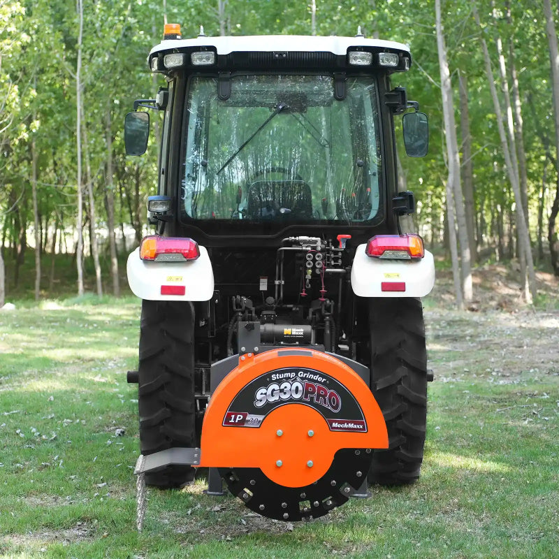 rear view of orange MechMaxx SG30PRO 3-point PTO stump grinder attached to tractor at gallery position 1