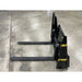 Black steel pallet forks with upright mounting plate and yellow Stinger and Made in USA labels on concrete floor