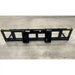 Black steel skid steer attachment frame with mounting brackets on concrete floor viewed from front angle