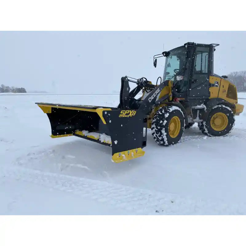 Right side view of yellow skid steer with black and yellow snow pusher attachment on snow-covered open area