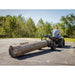 Rear angle of Swisher ATV log skidder hauling large timber on paved surface, gallery position 1