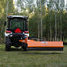 rear view of tractor with mounted orange MechMaxx 72-inch 3-point PTO offset ditch bank mower at gallery position 1