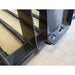 Close-up of black painted steel manure tine bucket attachment welds and tubular tine frame on concrete floor