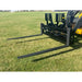 Black steel skid steer pallet fork attachment with two extended tines and perforated vertical backrest on grass field outdoors