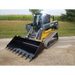 Yellow and black skid steer loader with tracked wheels and a toothed bucket attachment on compacted gravel pathway