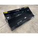 Black skid steer material bucket with smooth interior, reinforced edges, and yellow Stinger Series 2 72 markings on concrete floor