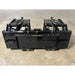 Black steel demolition grapple attachment with dual hydraulic arms on concrete floor in warehouse setting