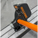 Close-up of black mechanical float attachment with orange handle mounted on aluminum screed rail on concrete floor