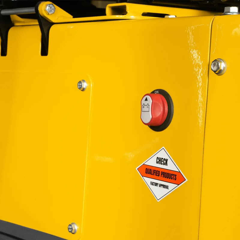 close-up of red safety switch and qualification label on yellow body panel of MechMaxx MEC12 mini excavator gallery position 1