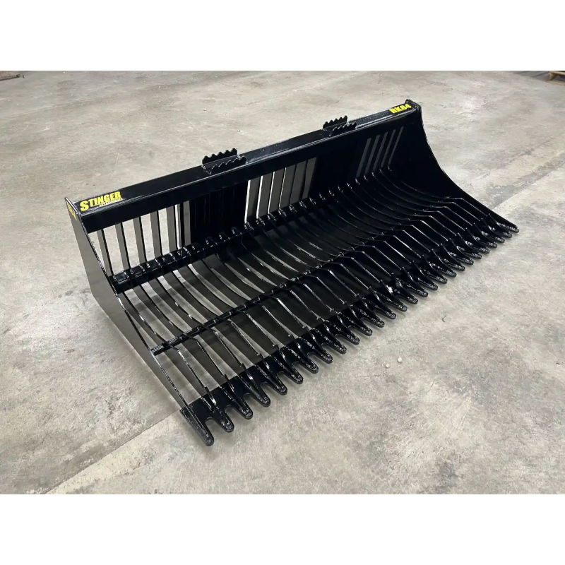 Black steel skid steer rock bucket attachment with narrow spaced tines and reinforced side panels on concrete floor
