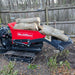 Red MechMaxx D50HTFL tracked dumper loaded with logs, front shovel lifting a log, gallery position 1