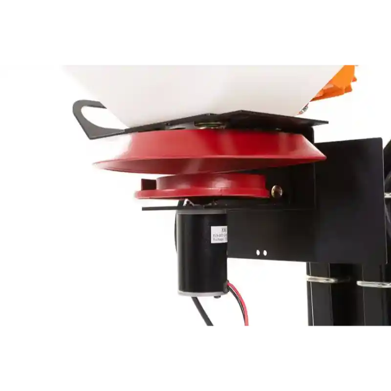 Close-up of red spinner assembly and black electric vibrator motor mounted beneath white hopper, gallery position 1