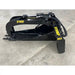 Black steel skid steer grapple attachment with serrated edges and hydraulic cylinder on concrete floor