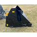 Black painted hydraulic dump bucket attachment mounted on tractor loader arm with visible hoses on grass field