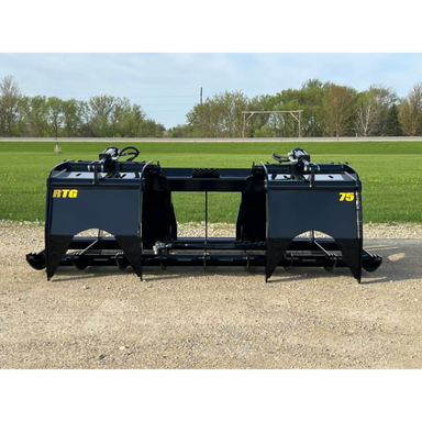 Black skid steer root grapple attachment with dual grapple arms, hydraulic cylinders, and reinforced steel frame on gravel surface