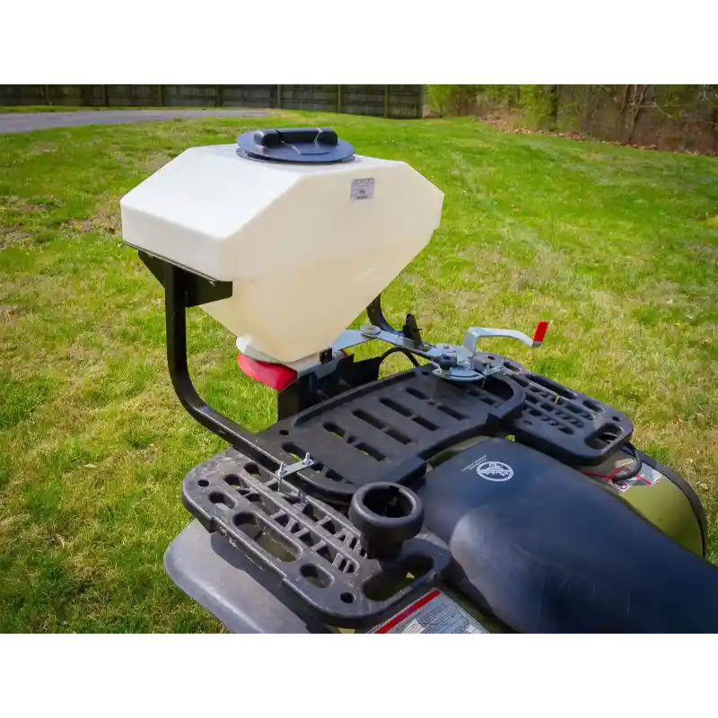 White poly hopper spreader mounted on rear cargo rack of green ATV, close view gallery position 1