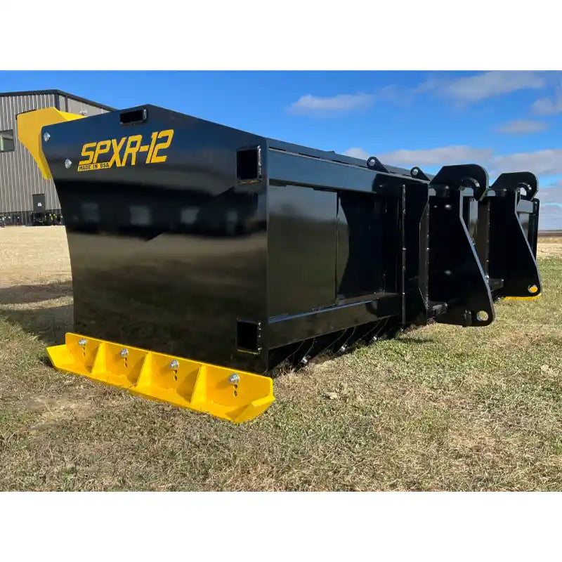 Black steel snow pusher attachment with yellow reinforced cutting edge and mounting brackets on grass surface