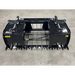 Black steel root and rock grapple attachment with dual hydraulic cylinders and heavy tines on concrete floor