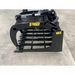 Black steel skid steer grapple attachment with thick spaced tines, hydraulic cylinder, and reinforced side plate on concrete floor