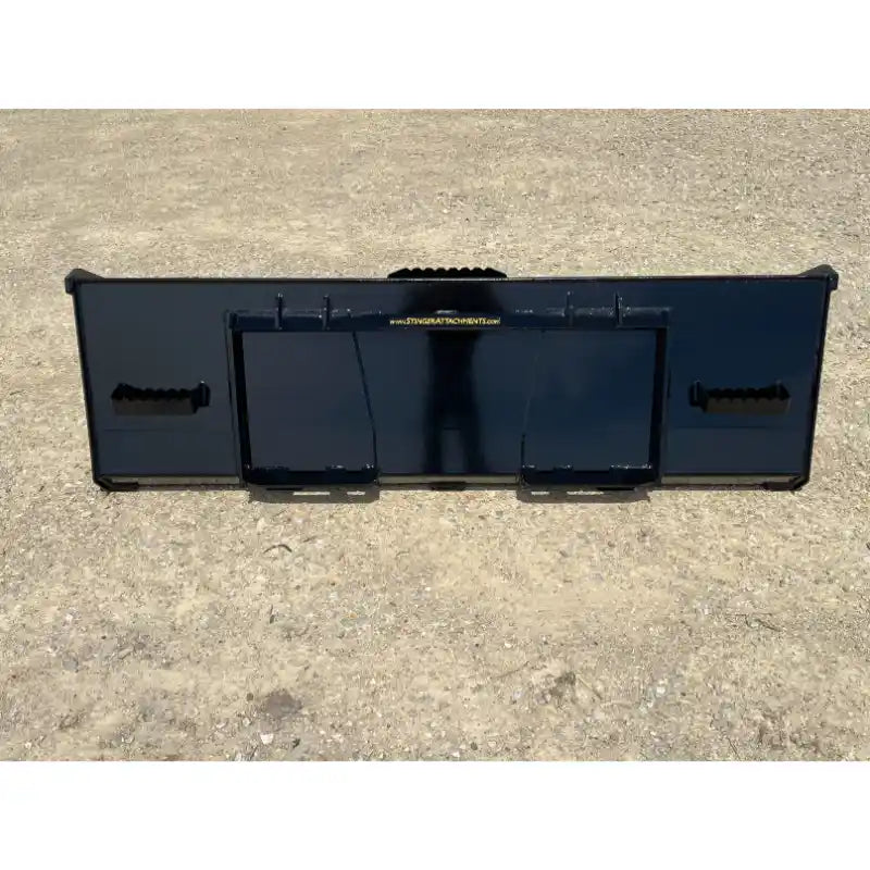 Flat black steel skid steer attachment plate with mounting slots and reinforced welds on compacted dirt surface