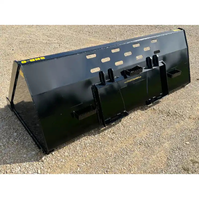 Black skid steer snow bucket attachment with rectangular ventilation slots and reinforced mounting plate on gravel surface