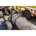 Close-up of Swisher ATV Log Skidder lifting large log with welded steel frame and knobby tires, gallery position 1