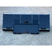 Front view of a black steel liquid slurry bucket attachment resting on gravel surface outdoors