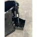 Black steel concrete bucket attachment with hydraulic dump cylinder and reinforced bottom edge on concrete floor