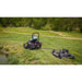 Zero-turn mower towing Swisher 66-inch finish cut mower with 14.5HP engine on grassy terrain, gallery position 1