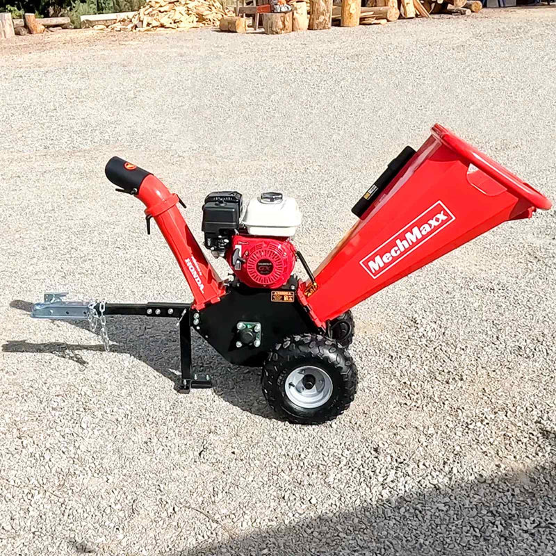Side profile of MechMaxx GS650 wood chipper with Honda GX200 engine, towbar, and gravel surface, gallery position 1