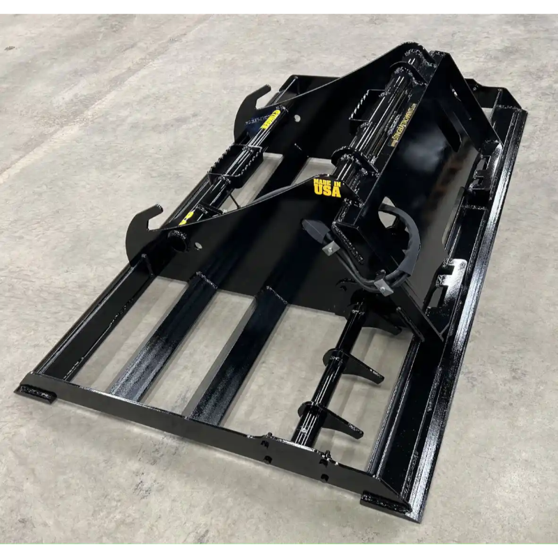 Back right angle view of black steel skid steer land plane attachment with hydraulic arms on concrete floor