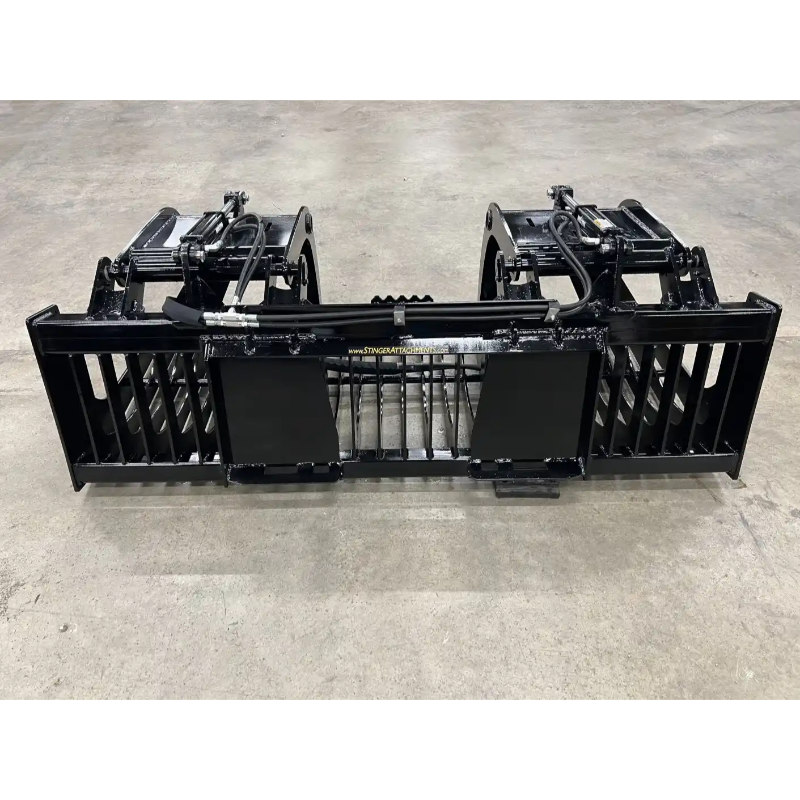 Black steel skid steer grapple attachment with dual hydraulic cylinders and reinforced tines on concrete floor