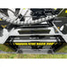 Close-up of Stinger Attachments TF3 Twister skid steer brush cutter showing warning label and hydraulic hose, 800x800 square image.