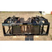 Black welded steel manure grapple attachment with dual hydraulic cylinders and wide spaced tines on concrete surface outdoors