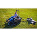 Operator using a ride-on mower towing a Swisher 44-inch finish cut mower on a grassy field, gallery position 1