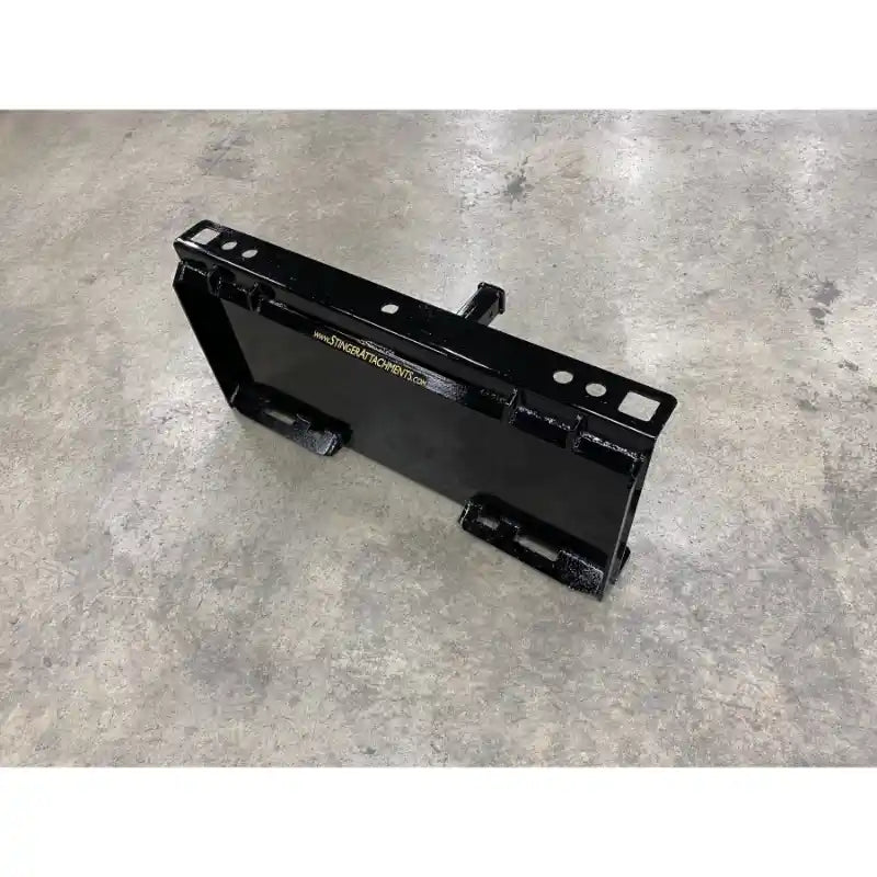 Black steel receiver hitch attachment plate with mounting holes and weld points on concrete floor