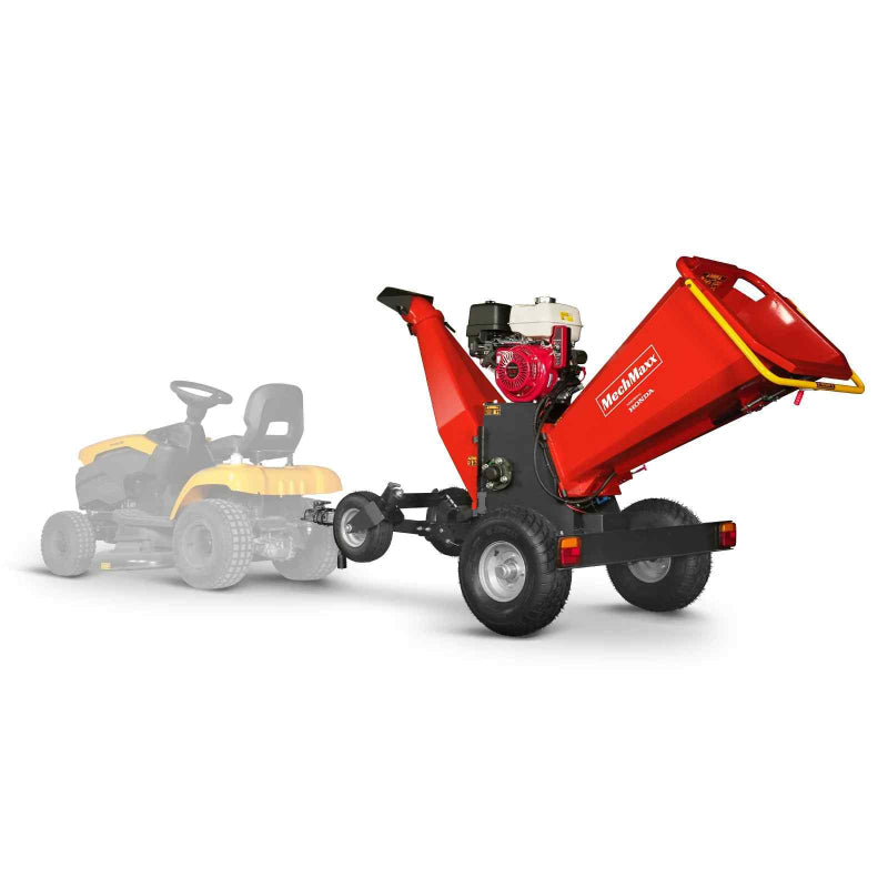 MechMaxx 6 inch Honda GX390 drum wood chipper in front view with yellow riding mower faded in background gallery position 1