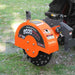 side angle of orange MechMaxx SG30PRO stump grinder with carbide teeth attached to tractor 3-point hitch at gallery 1