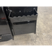 Close-up of black steel loader attachment section with welded serrated edge and mounting bracket on concrete floor