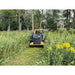 Skid steer brush cutter clearing dense vegetation in a wooded area viewed from front gallery position 15 square image