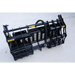 Black steel compact clam grapple attachment with hydraulic hose and mounting brackets on concrete surface outdoors
