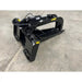 Black steel skid steer stump bucket attachment with hydraulic grapple arm and serrated edges on concrete floor