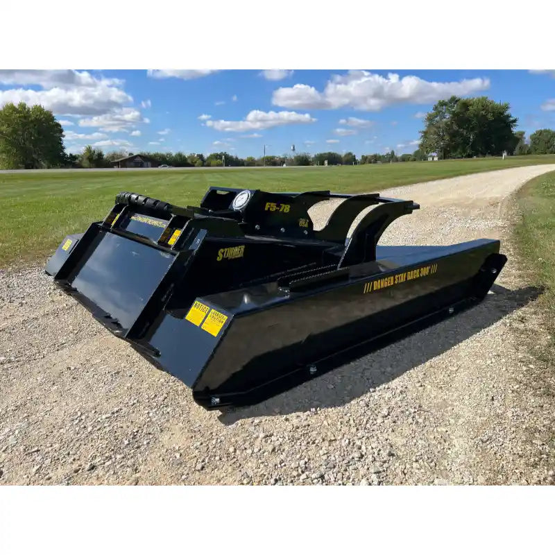 Gallery image 28 of Stinger Attachments TF5 Twister skid steer brush cutter on gravel road, 800x800 square view