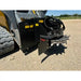 Black skid steer stump grinder attachment with cutting teeth, hydraulic hoses, and steel safety guard on dirt surface