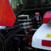 close-up of hydraulic hose connections and metal fittings on tractor attachment at gallery position 1