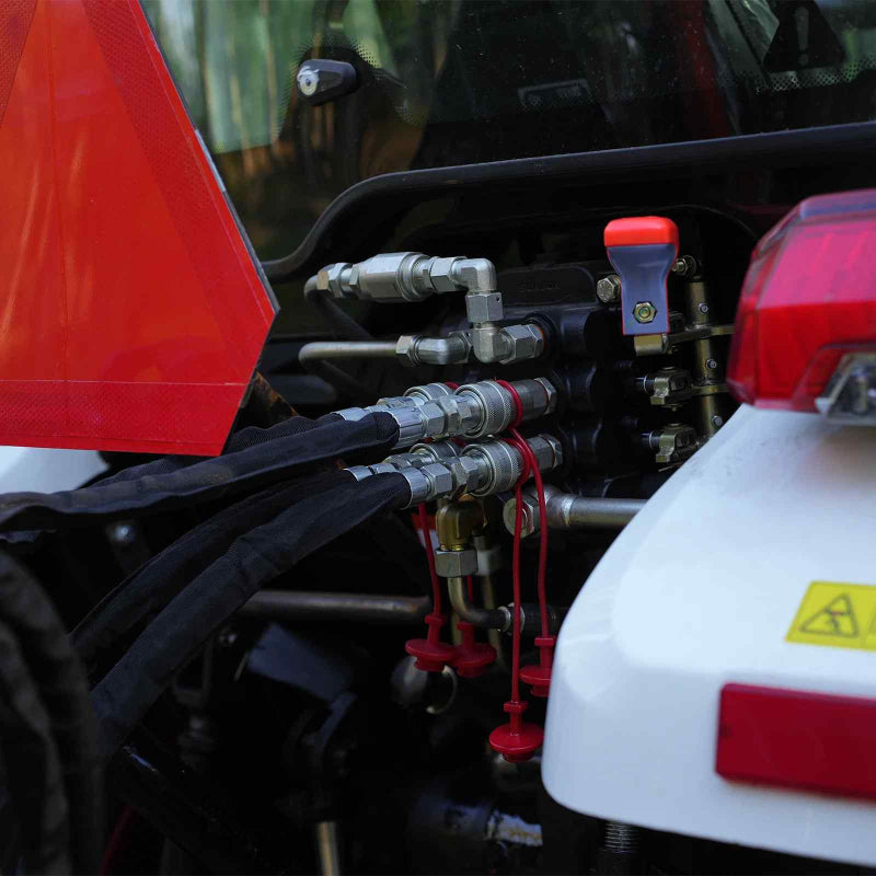 close-up of hydraulic hose connections and metal fittings on tractor attachment at gallery position 1