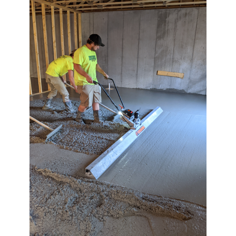 Two construction workers leveling concrete using MBW WS500 ScreeDemon vibratory wet screed, gallery position 1