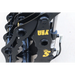 Close-up of black steel grapple attachment with visible hydraulic hoses and yellow "Made in USA" marking on light surface