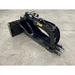 Black steel stump bucket with hydraulic grapple arms and serrated claws on concrete floor surface