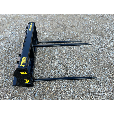 Stinger Attachments BS1 Series 1 Skid Steer Bale Spear, gallery image 2, 800x800 square view on gravel surface